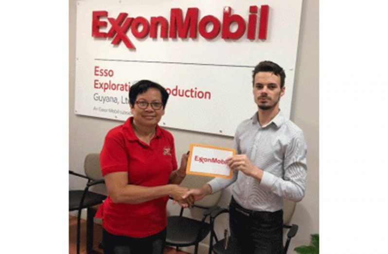 GMR&SC secretary Cheryl Gonsalves collects the sponsorship cheque from Exxon’s Nicholas Yearwood.