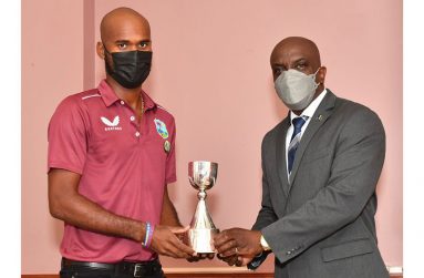 West Indies captain Kraigg Brathwaite shares the recently won Richards-Botham trophy with Barbados Minister of Sports, Charles Griffith.