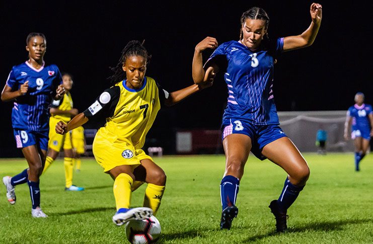 St Lucia’s Krysan St Louis (#10) who scored both goals in her team 2-1 win, is about to take on Bermuda defender Jenna Rempel (#3) during their CONCACAF U-20 Women’s Championship Qualifiers. (Samuel Maughn photo)