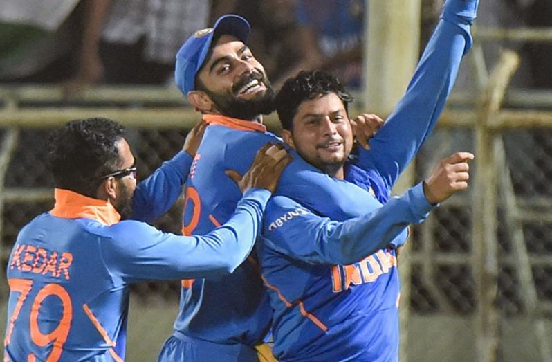 Kuldeep Yadav celebrates with skipper Virat Kohli after completing his hat-trick during the 2nd ODI against West Indies.(PTI)