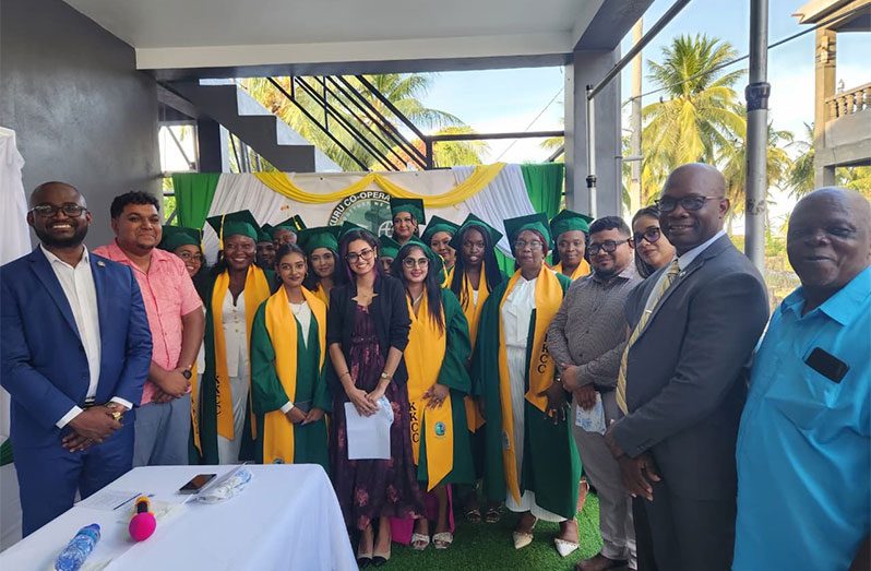 From left, Dr Kofi Dalrymple and Mahaicony/Abary NDC Vice Chairman, Mr. Leon Wordsworth, with the graduates and lecturer Ms. Chandradai Devina Persaud, Regional Chairman, Mr. Recardo Phillips; Regional Executive Officer, Ms. Mary Samaroo; Mr. Hansen Elliot, Principal of the Kuru Kuru Cooperative College and Mr. Matthews, representative of Kuru Kuru College