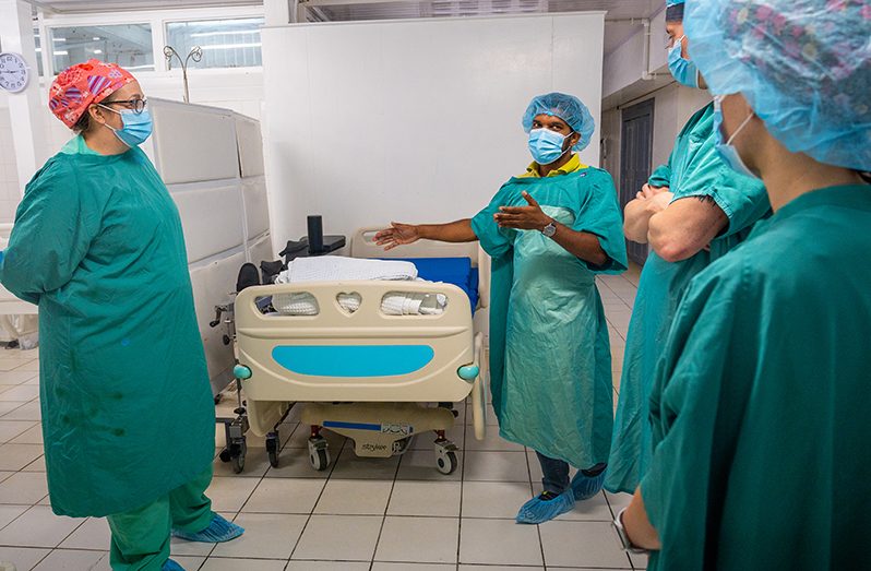 Dr. Cheman Ramdharry provides a tour of the operating theater to LAMAT surgery team members at GPHC