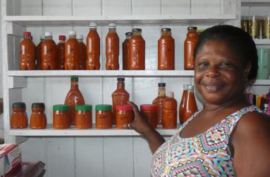 Nathelyn Benn-Dequoy showcasing some of her bottled pepper sauce.