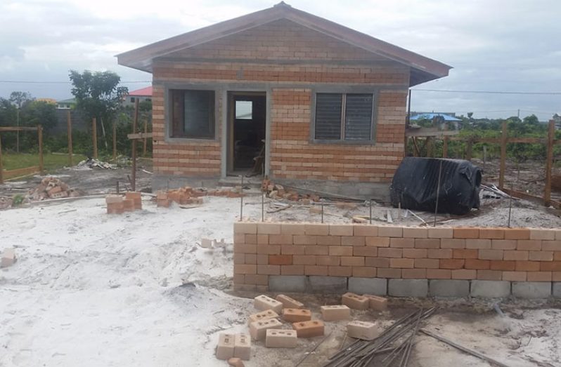 One of the model low-income houses made with laterite blocks being constructed in Amelia’s Ward