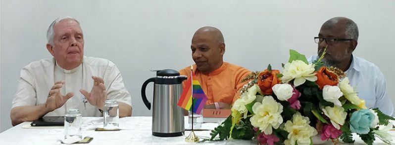 Bishop Francis Alleyne makes a point while other panelists, Swami Aksharananda (centre) and Brother Wazir Baksh (right) look on.