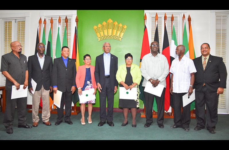 HISTORIC MOMENT: President David Granger, centre, and the newly sworn-in Local Government Commissioners on Monday. Thery are, from left: Mr Norman Whittaker; Mr Andrew Garnett; Mr Clement Corlette; Ms Joan Ann Ramascindo; Ms Carol Sooba; Mr Mortimer Mingo; Mr Clinton Collymore; and Mr Marlon Williams (Photo by Samuel Maughn)