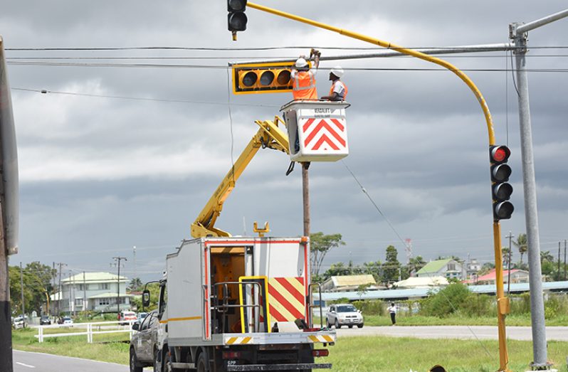 Workers install new traffic systems on the intersection of Sandy Babb Street and Vlissengen Road (Samuel Maughn photo)