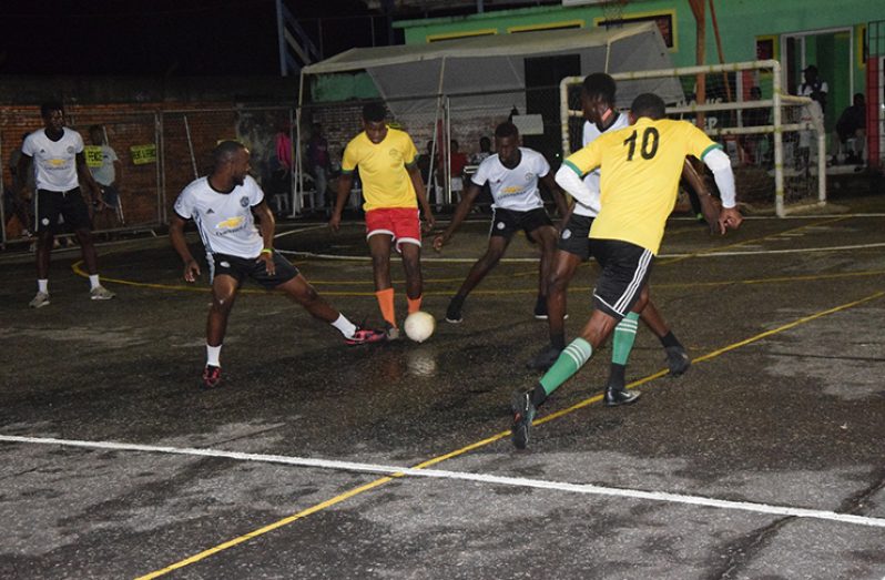 Action between West Side ballers (yellow) and Good Fellas in the Mohamed’s Enterprise/ExxonMobil annual futsal tournament, at the Mackenzie Sports Club Hard Court, in Linden