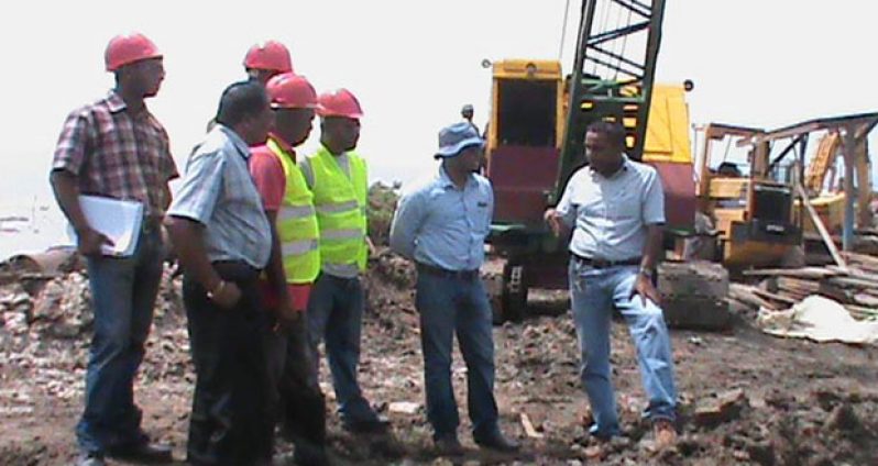 CEO of NDIA, Mr Lionel Wordsworth giving an explanation to Minister Alli Baksh about construction work on the Lima pump station project.