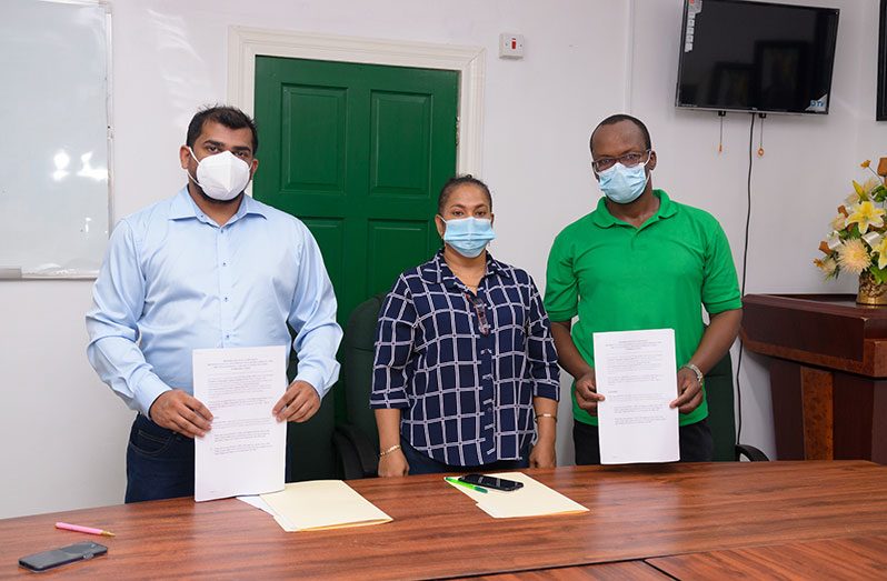 GTT’s representative, Mark Singh; Chief Labour Officer, Michelle Baburam, and GPTWU President, Harold Shepard during the signing ceremony (Delano Williams photo)