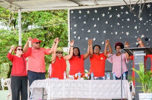 Opposition Member of Parliament,Gail Teixeira, Ministers of Natural Resources and Social Protection, Raphael Trotman and Amna Ally respectfully join hands with GTUC President,Coretta Mc Donald and other union representatives in a show of solidarity on Monday at the National Park. (Samuel Maughn photo)