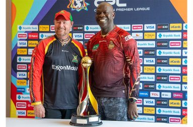 Guyana Amazon Warriors Head Coach Lance Klusener (left) and Trinbago Knight Riders Assistant Coach Ottis Gibson with the prized trophy on Saturday (PHOTO: News Room)