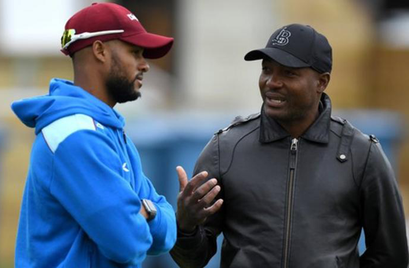Brian Lara (right, speaking to Shai Hope in 2017) retired from international cricket in 2007
