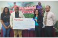 ExxonMobil’s Suzanne De Abreu (second from right) presents the ceremonial cheque to Co-Director of the Petra Organisation, Troy Mendonca, in the presence of another member of the organisation and Nicholas Fraser (far right) of Allied Arts Unit, Ministry of Education