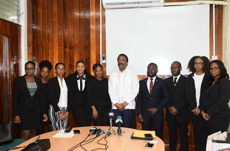 Attorney General and Minister of Legal Affairs Basil Williams flanked law students currently attending the Hugh Wooding Law School and the University of Guyana.