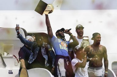 Lebron James, centre, holds up the NBA Championship trophy alongside Cavaliers teammates yesterday in Cleveland. (John Minchillo/AP)