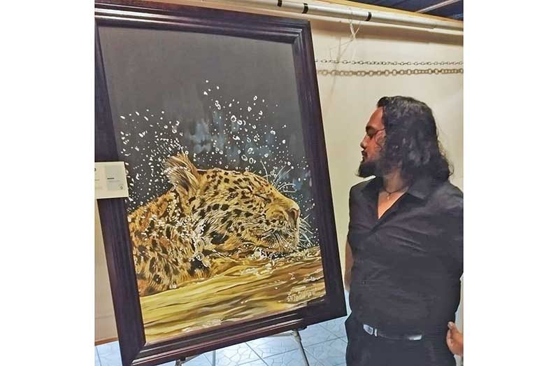 Leon “Lee” Hardowar with one of his paintings