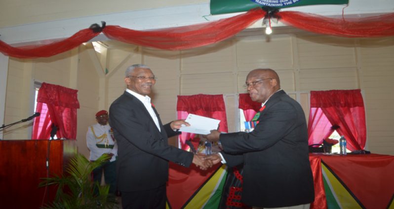President David Granger handing over cheques to the tune of $4.8 million to President of the Legion George Gomes (Cullen Best Nelson photo)
