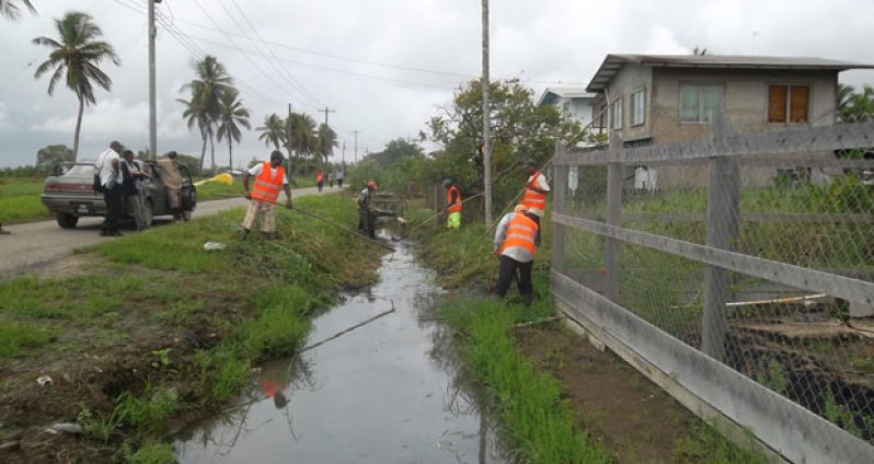Community Enhancement Workers helping to improve drainage in Leguan