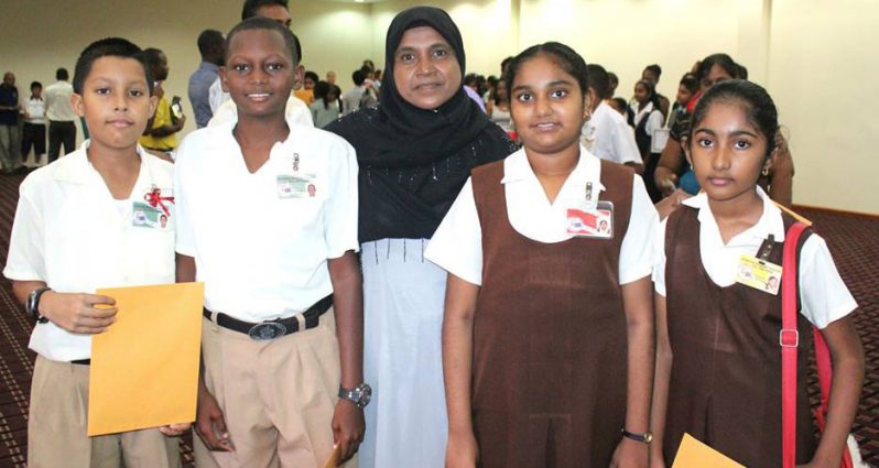 Zailmoon Samad, the head teacher of the Leonora Primary School, with four of her five students who secured a place at Queens College this year. Teacher Samad is among 16 headteacehrs who have been approved to benefit from duty free concessions.