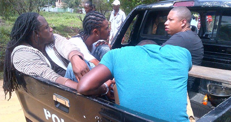 ‘NABBED’: The four men on Monday in the back of a police pickup