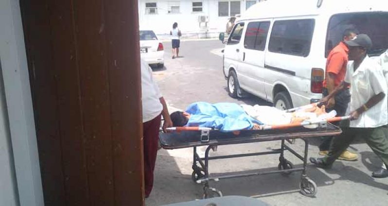 Ms. Gravesande being taken into the West Demerara regional Hospital