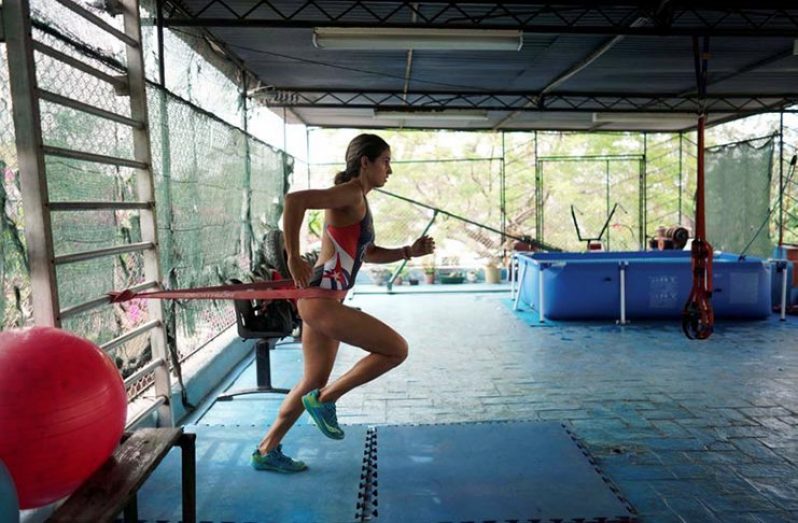 Elite Cuban triathlete Leslie Amat trains on the roof of her home amid concerns about the spread of the coronavirus disease (COVID-19) outbreak, in Havana, Cuba, April 17, 2020. REUTERS/Alexandre Meneghini