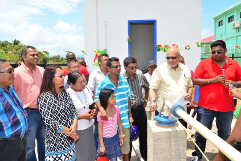 GWI's Chief Executive Officer Shaik Baksh, President Donald Ramotar and Housing and Water Minister Irfaan Ali check the water flow from the newly commissioned Lethem well, on Saturday last. Also in photo are Minister of Culture Youth and Sport Dr Frank Anthony and Amerindian Affairs Minister Pauline Sukhai.