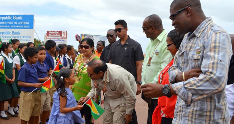 Prime Minister Moses Nagamootoo, with wife Sita, listens to a nursery school student soon after he arrived at Lethem on Saturday morning. Also in photo, from the Prime Minister’s left, are Ministers Joseph Harmon, Volda Lawrence and David Patterson