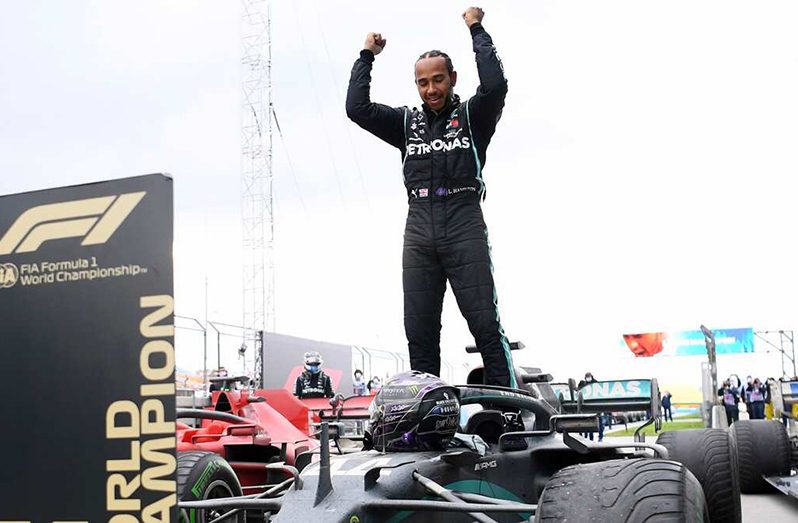 Mercedes driver Lewis Hamilton of Britain celebrates after winning the Turkish Formula One Grand Prix. (AP).