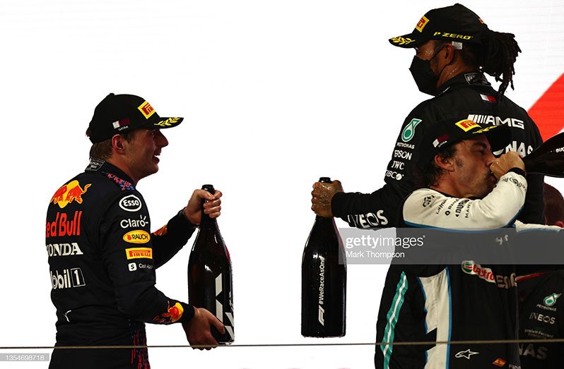 Race winner Lewis Hamilton of Great Britain and Mercedes GP, Second placed Max Verstappen of Netherlands and Red Bull Racing and Third placed, Fernando Alonso of Spain, and Alpine F1 Team celebrate on the podium during the F1 Grand Prix of Qatar at Losail International Circuit on November 21, 2021 in Doha, Qatar. (Photo by Mark Thompson/Getty Images)