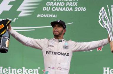 Mercedes driver Lewis Hamilton celebrates winning the race.