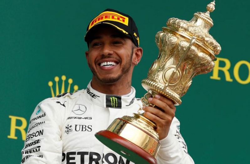 Mercedes' Lewis Hamilton celebrates his win on the podium.