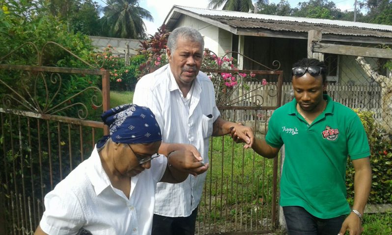 MP, Jermaine Figuera assisting the elderly to  vote in Linden