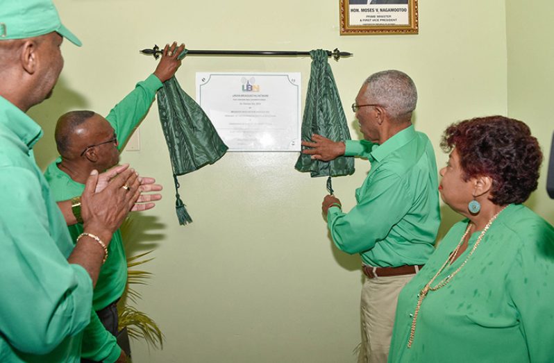 President David Granger (right) and Regional Chairman (Region 10) Renis Morian unveil a plaque at the Linden Broadcasting Network. Also in photo are Minister of Social Protection, Amna Ally (left of President Granger) and Director-General, Ministry of the Presidency, Joseph Harmon (left)