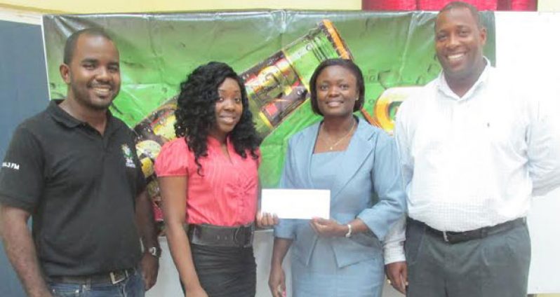 Ms Janella Harry collecting the cheque from Ms Shondel Easton. At left is Keiron Williams and,  at right, is Mortimer Stewart