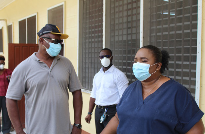 Regional Executive Officer Orrin Gordon in conversation with Dr Tracey Bovell
Emergency Medicine Specialist at GPHC, while Medical Superintendent at Linden Hospital
Complex, Dr Joseph London pays attention as they tour the isolation facility at Wismar hospital.