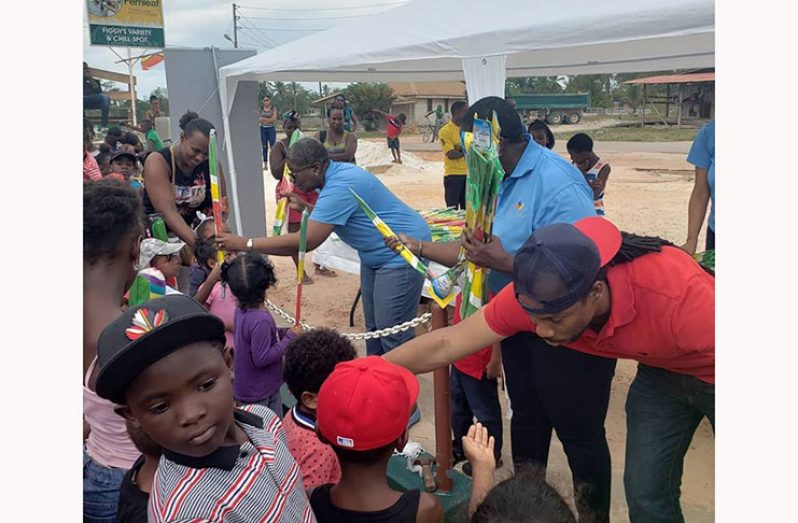 Member of Parliament Jermaine Figueira taking part in a massive kite distribution in communities in Linden