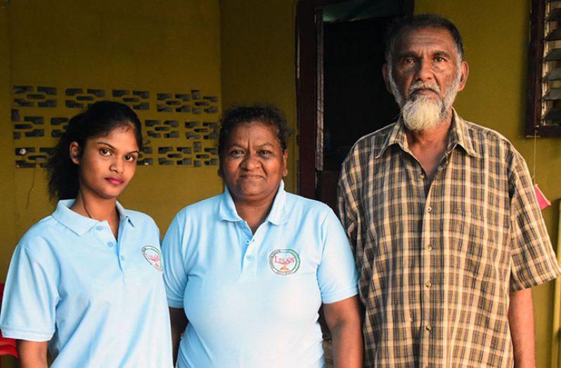 Fareed (centre) shares a moment with her daughter and husband (Adrian Narine photo)