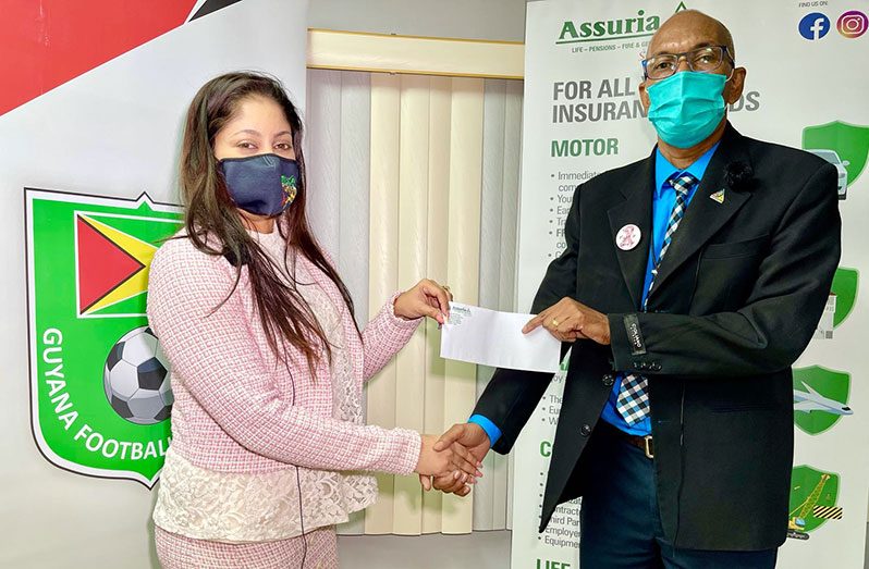 GFF Marketing Committee Chairperson, Lisa Ahmad, receives a cheque from Erwin Daniels, Head of the Life, Pensions and Health Department at Assuria.