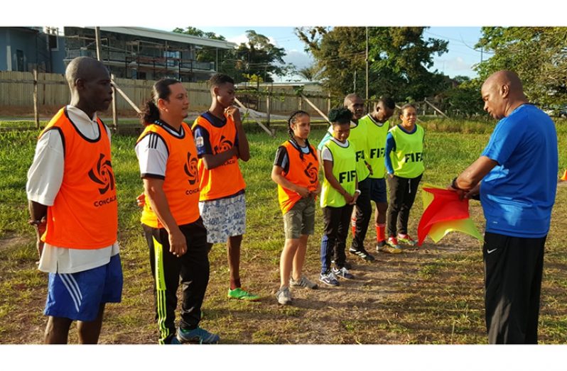 Referees listen attentively to FIFA Member Association’s technical instructor Roy McArthur.