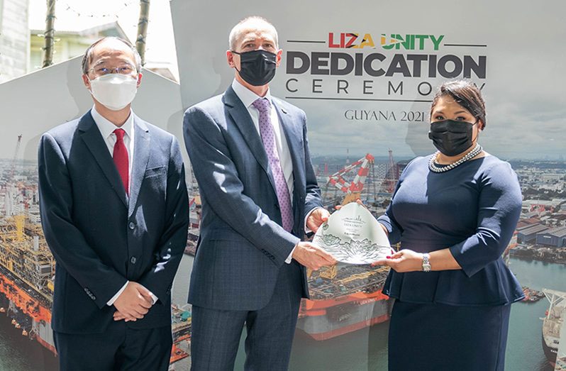 President of ExxonMobil Guyana, Alistair Routledge, and President of CNOOC Petroleum Guyana Limited, Liu Xiaoxiang, hands over a token of appreciation to “God Mother”, First Lady, Arya Ali