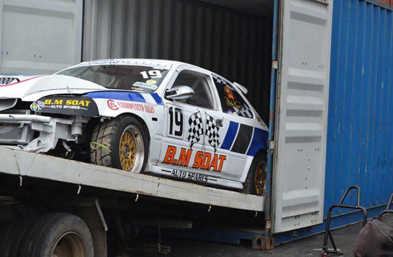 Rameez Mohaamed’s Honda Civic is loaded into the container. (Stephan Sookram photos)