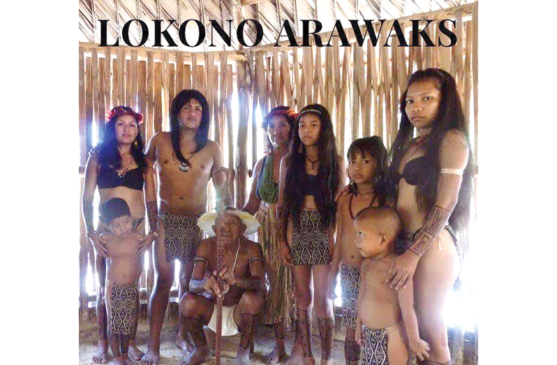 Elder Simon can be seen on the cover photo of his son-in-law’s book seated in traditional attire and with temporary body tattoos, surrounded by some of his grandchildren and great grandchildren.