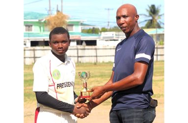 DCB official Shawn Massiah presents Lomar Seecharran his Man-of-the-Match trophy at LBI