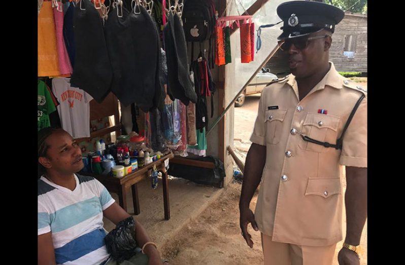 Assistant Superintendent Kevin London speaks with a businessman of the Kumaka Waterfront, Moruca community.