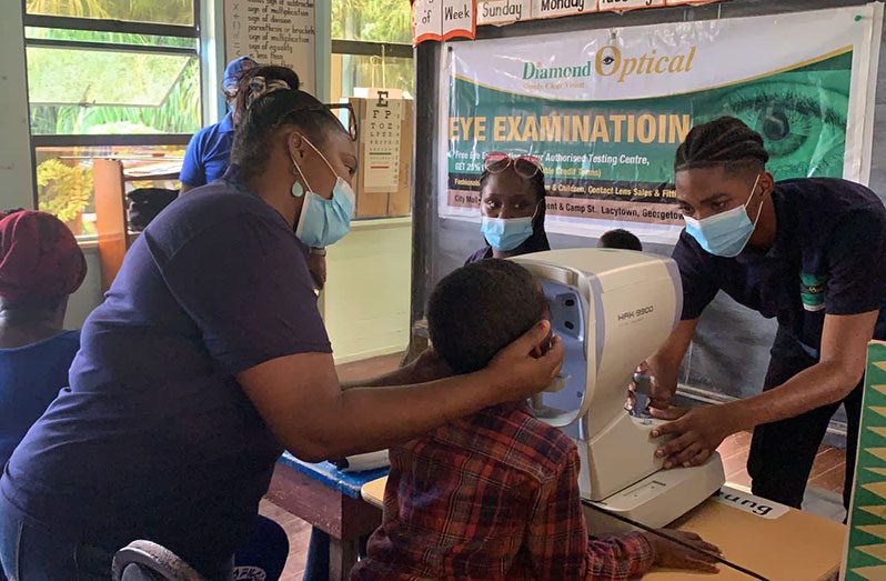 Young resident of Low Wood receives eye test during a community outreach