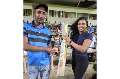 The lucky fan on the left received the bat from Annalisa Beharry, a representative of the project