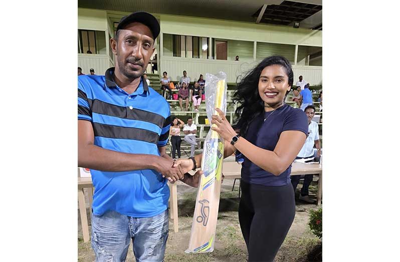 The lucky fan on the left received the bat from Annalisa Beharry, a representative of the project