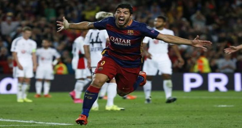 Barcelona's Luis Suarez celebrates after scoring a goal against Bayer Leverkusen during their Champions League Group E soccer match at Camp Nou stadium in Barcelona, Spain, yesterday. (Reuters/Sergio Perez)